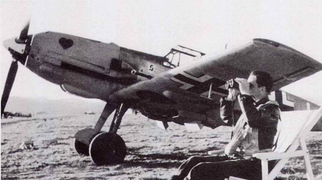 Luftwaffe pilot with binoculars beside a Messerschmitt BF-109 on the airfield